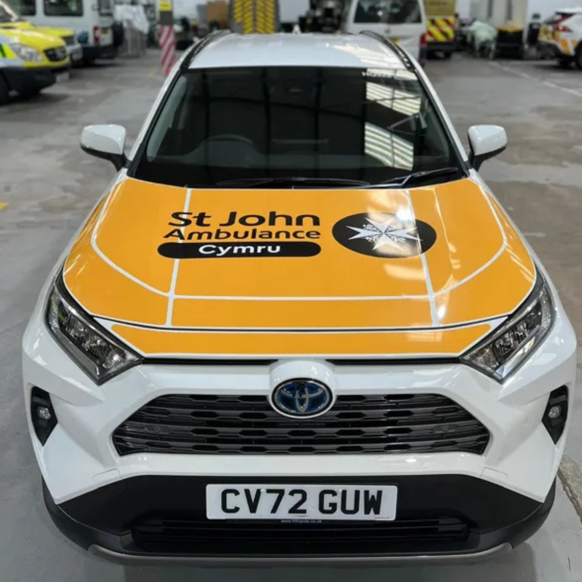 A 4x4 falls response unit car. White and yellow and displays the St John Ambulance Cymru logo on the front bonnet.