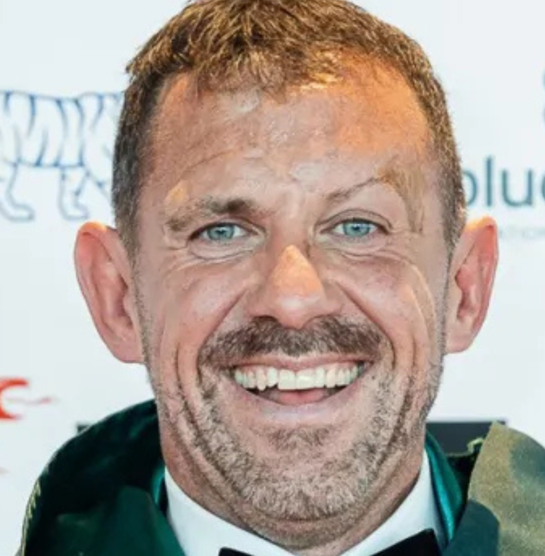 Traitors finalist and St John Ambulance Cymru ambassador Andrew Jenkins smiling.